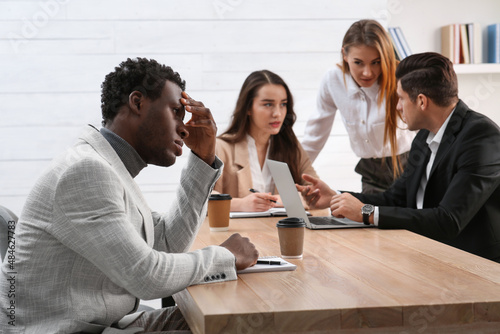 African American man suffering from racial discrimination at work