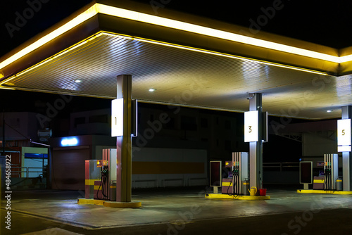 Car filling station at night.