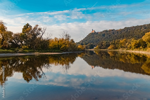 Beautiful autumn or indian summer view with reflections at the famous Bogenberg, Danube, Bavaria, Germany