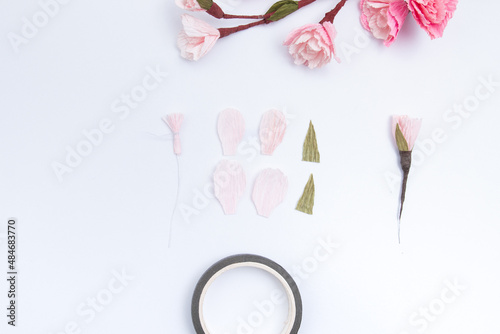 Create a sakura flower from 4 light pink crepe paper petals. Cut out the petals and fasten with a thread on a wire with a stamen