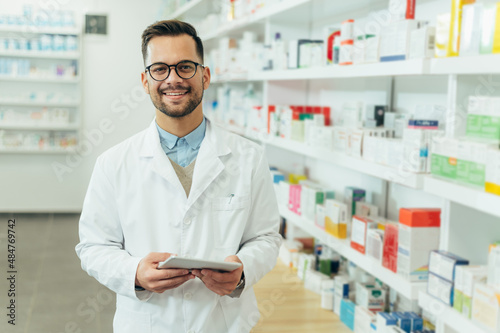 Portrait of a handsome pharmacist working in a pharmacy