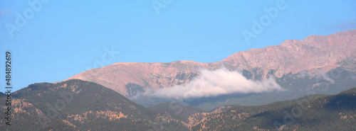 Panoramic image of Low lying clouds hug the Rocky Mountains outside of Colorado Springs