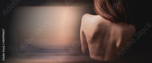 Young woman stands with bare back