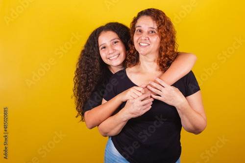 Grandmother and niece, Brazilian, Latin American, curls, afro hair, curly, smiling, hugging, family photo, beautiful. Mother's Day, Fraternity, Love.