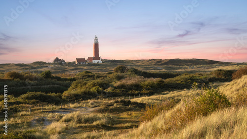 Dune landscape with a lighthouse on the Wadden Island of Texel, the Netherlands.