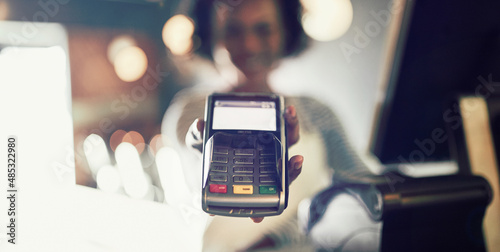 Restaurant waitress holding an electronic card payment machine