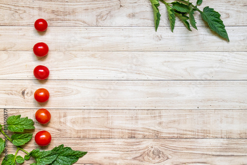 List cherry tomatoes on wooden table background