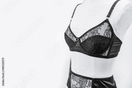 Stylish black lace lingerie underwear on woman mannequin, white background