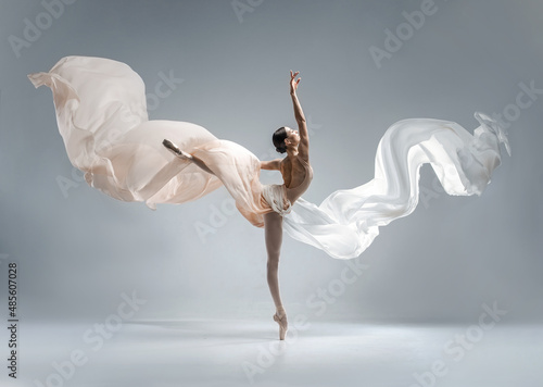 Beautiful ballerina dancing in the body color ballet leotard with body color cloth. She danced on ballet pointe shoes.