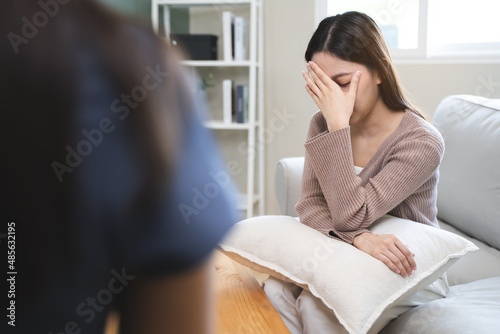 Young woman in a mental therapy session talking with a psychologist in the office.