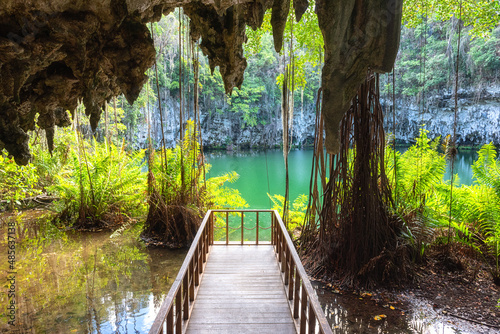 Three eyes cave in Santo Domingo, los Tres Ojos national park, Dominican Republic. Scenic view of limestone cave, beautiful lake and tropical plants, nature landscape, outdoor travel background