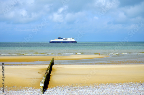 car ferry on the english channel between Dover and Calais seen from the beach