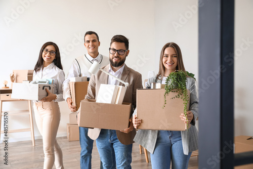 Business people holding boxes with things in office on moving day