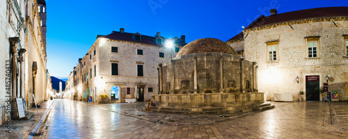 Panoramic photo of Dubrovnik Old Town at night, including Onofrio Fountain, Stradun and Dubrovnik City Bell Tower, Croatia