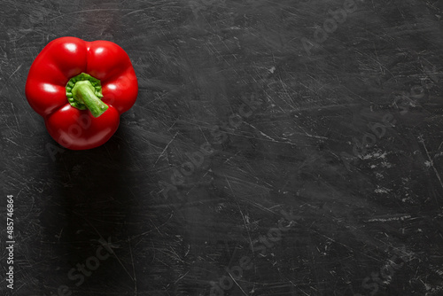 Pepper sweet red bulgarian one, on dark background, top view, with space to copy text.