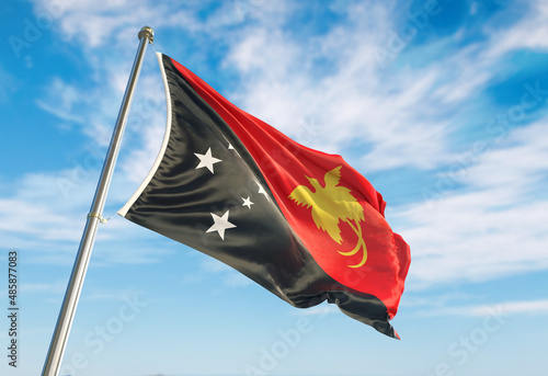 3d rendering Papua New Guinea flag waving in the wind on flagpole. Perspective wiev Papua New Guinea flag waving a blue cloudy sky