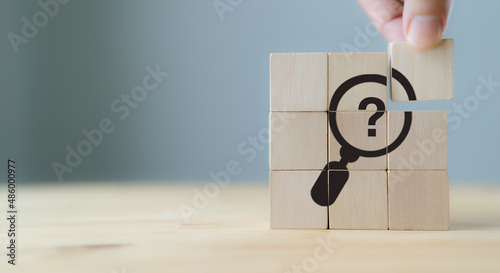 Problems and root cause analysis concept. Define problems to find solution. The wooden cubes with illustration magnifying glass to analyze question mark sign on grey background and copy space.