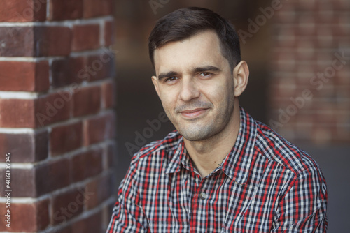 Close up street portrait of happy millennial handsome man 30-35 years old in casual clothes