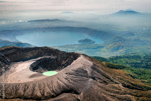 Aerial view of Santa Ana Volcano with lake and mountain cloud backdrop