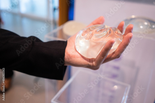 A young man is experimenting with breast augmentation silicone for cosmetic surgery.