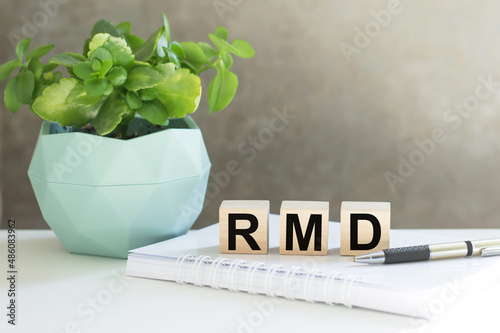 RMD required minimum distributions. text on wood cubes. text in black letters on wood blocks