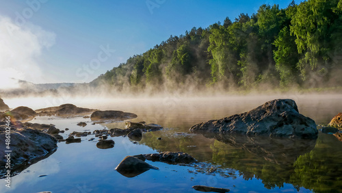 evaporation of water in the river early in the morning at dawn