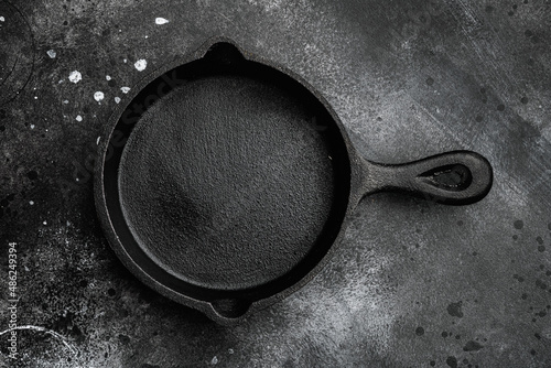 Empty frying pan with copy space for text or food with copy space for text or food, top view flat lay , on black dark stone table background