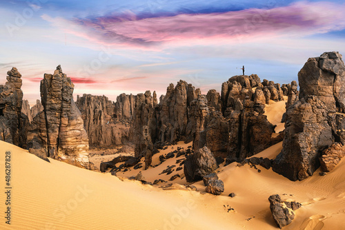 A view of the Algeria desert with rocky cliffs and a colorful sky. August 12, 2019