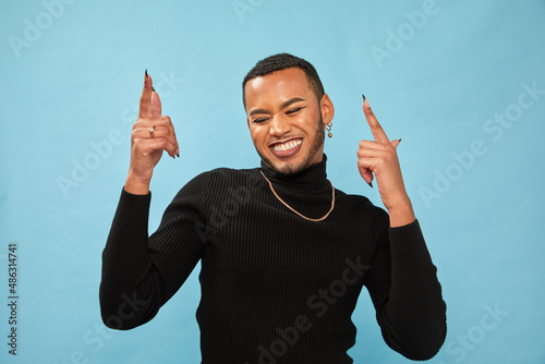 Studio portrait of smiling queer man