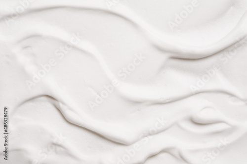 Mousse shaving cream or facial cleanser product or soft soap foam texture background copy space.