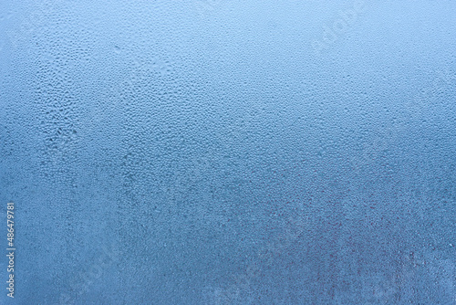 Water droplets condensation background of dew on glass, humidity and foggy blank background. Condensation on the glass of metal-plastic window. Outside the window, bad weather, rain