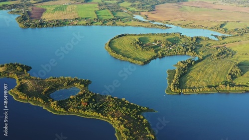 4K Blue Water Of Lake River And Green Countryside Landscape With Growing Greenery Forest. Aerial View Of Rivers Coast Islands.