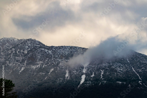 Foggy Snowy Mountains. Magical atmosphere of a foggy morning in a mountain. Copy paste banner space. 
