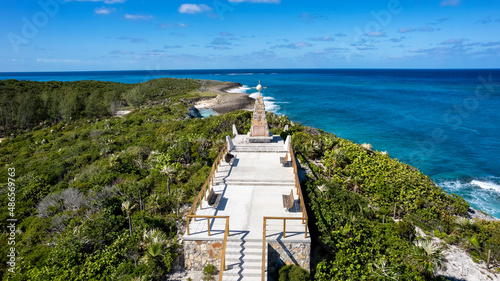 Aerial view of the Christopher Columbus monument at the nort cape of Long Island, Bahamas, surrounded by palm trees, mangroves and blue sea