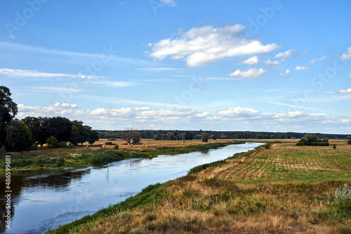the Warta River and arable fields after the summer harvest