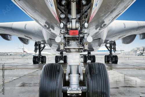 close view of landing gear under a big jet plane