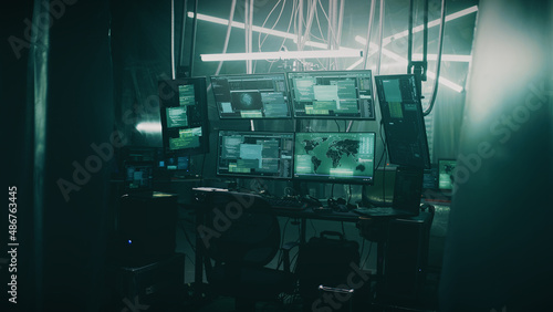 Dark hacker refuge with lamps and tables and computer equipment with programs for cyber crimes and cyber attacks