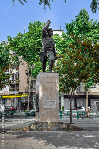Tirana, Albania - June 21, 2021: Monument to the Partisan by Andrea Mano in Tirana, 1949. Sculpture on a pedestal with a sign POPULLI I TIRANES PARTIZANE VE TE RENE PER CLIRIMIN E KRYEQYTETIT
