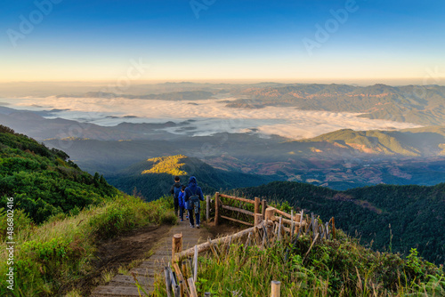 Tropical forest nature landscape view with toursits mountain range and moving cloud mist at Kew Mae Pan nature trail, Doi Inthanon, Chiang Mai Thailand