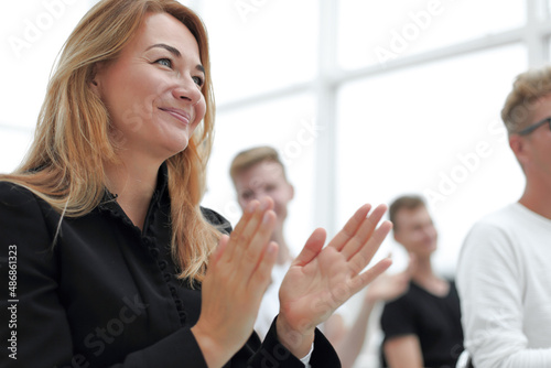 close up. young woman applauding sitting in the conference room