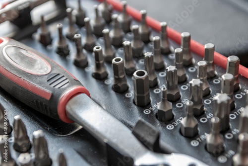 Screwdriver bits in toolbox as assorted screwing toolkit organizer with torx bits, cross bits and variation of replaceable screw adapters as professional equipment for workers and repairman mechanics