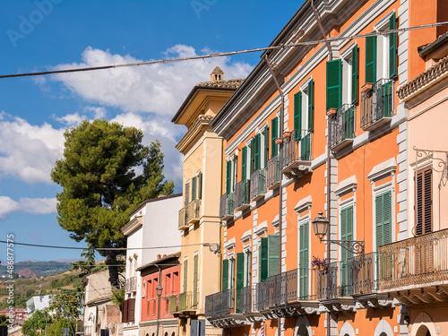 Facade of the colorful block with balconies in a typical Abruzzo town (Italy)