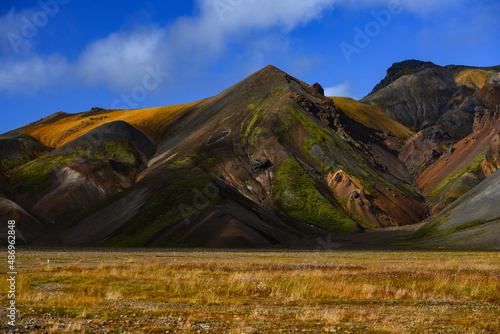 A grassy valley surrounded by colorful rhyolite hills, Landmannalaugar, Fjallabak Nature Reserve, Central Highlands, Iceland
