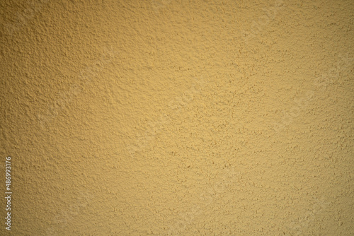 Blank concrete wall yellow color for texture background. New surface looks rough. Wallpaper shape. Backdrop texture wall and have copy space for text. Painted cement Surface design banners