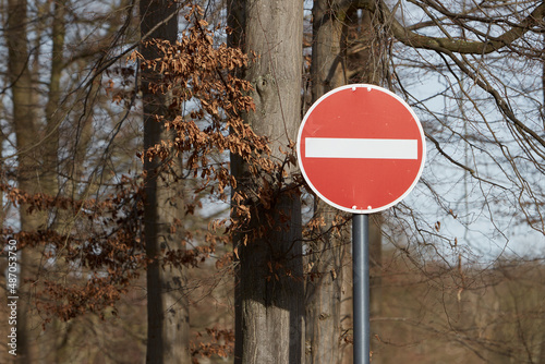 Sign entry into the one-way street forbidden, trees in the background