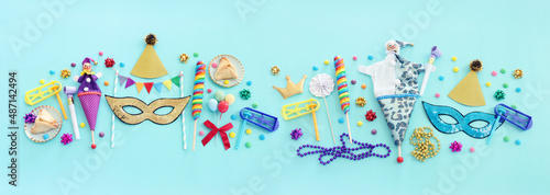 Purim celebration concept (jewish carnival holiday) over blue background