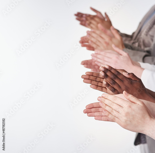 Rounds of applause. Shot of a group of people clapping their hands together.