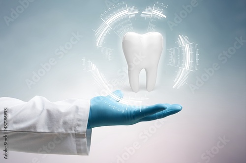 The dentist looks at the hologram of the tooth. Concept for innovative technologies, medicine of the future, tooth snapshot.