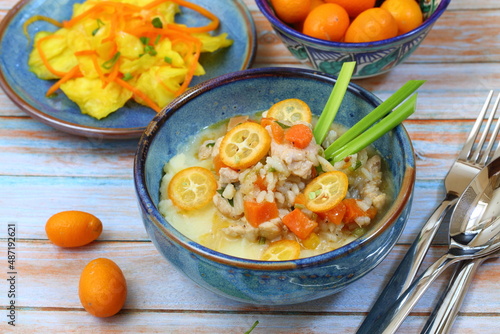 Turkey stew with vegetables, kumquat and mashed potatoes on a blue background