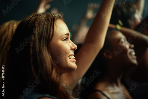 Young girls in an audience enjoying their favorite bands performance. This concert was created for the sole purpose of this photo shoot, featuring 300 models and 3 live bands. All people in this shoot